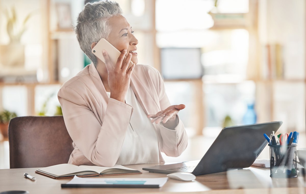 A businesswoman on a phone call at her desk