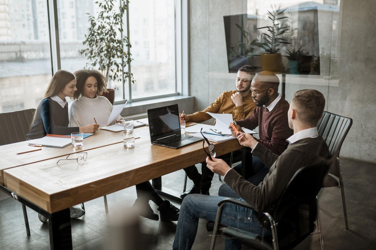 A team reviewing documents together around a boardroom table