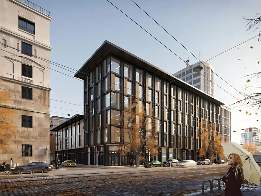 A dark-framed mid-rise office building on a city street corner in autumn