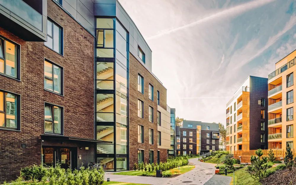 New mid-rise apartment buildings around a landscaped courtyard path